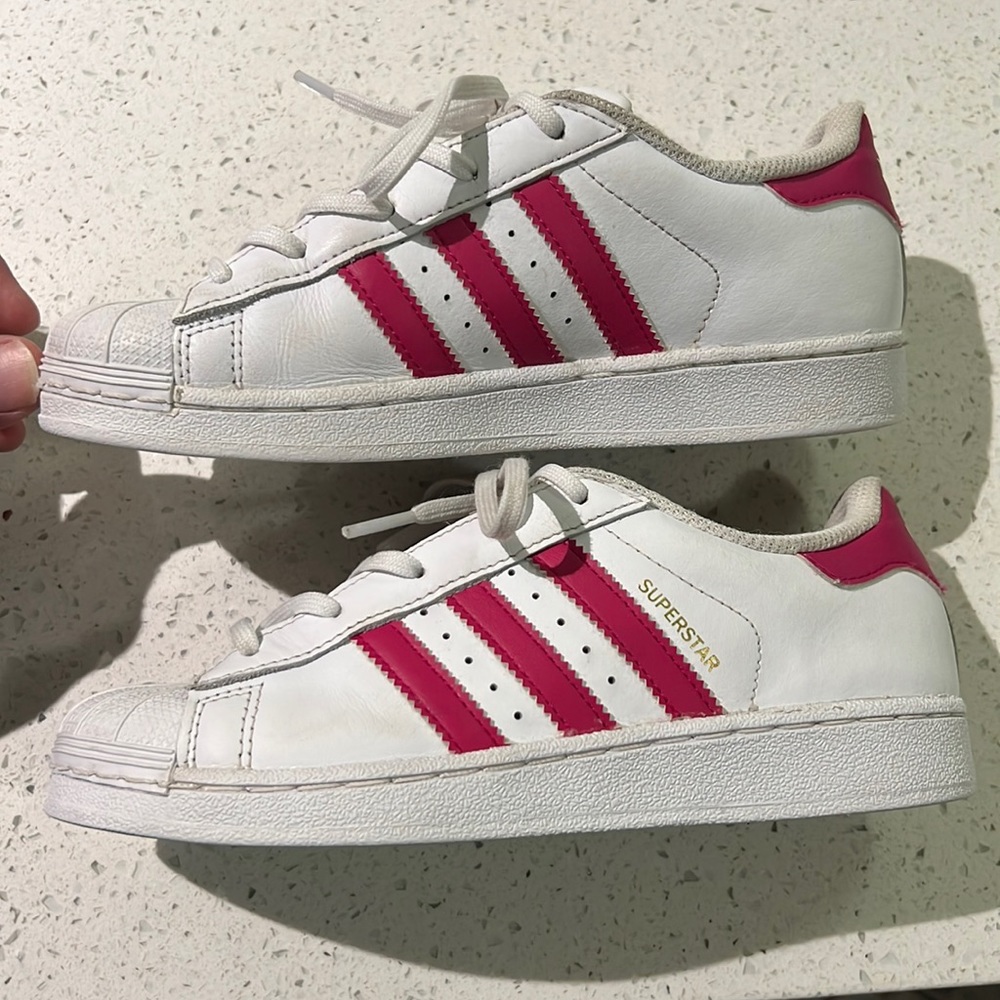 Pink and white Adidas superstar